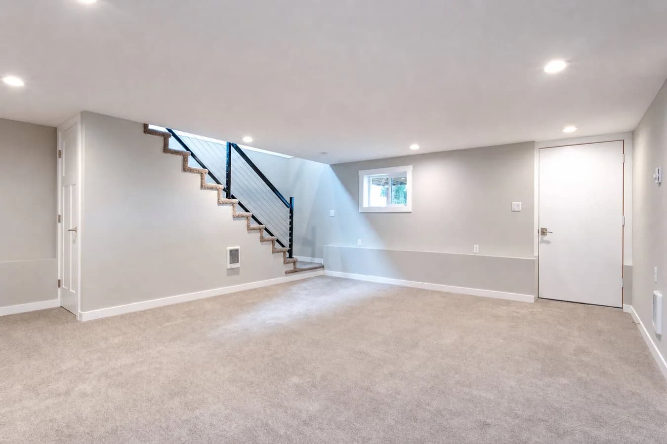A finished basement emptied down to bare carpet and walls